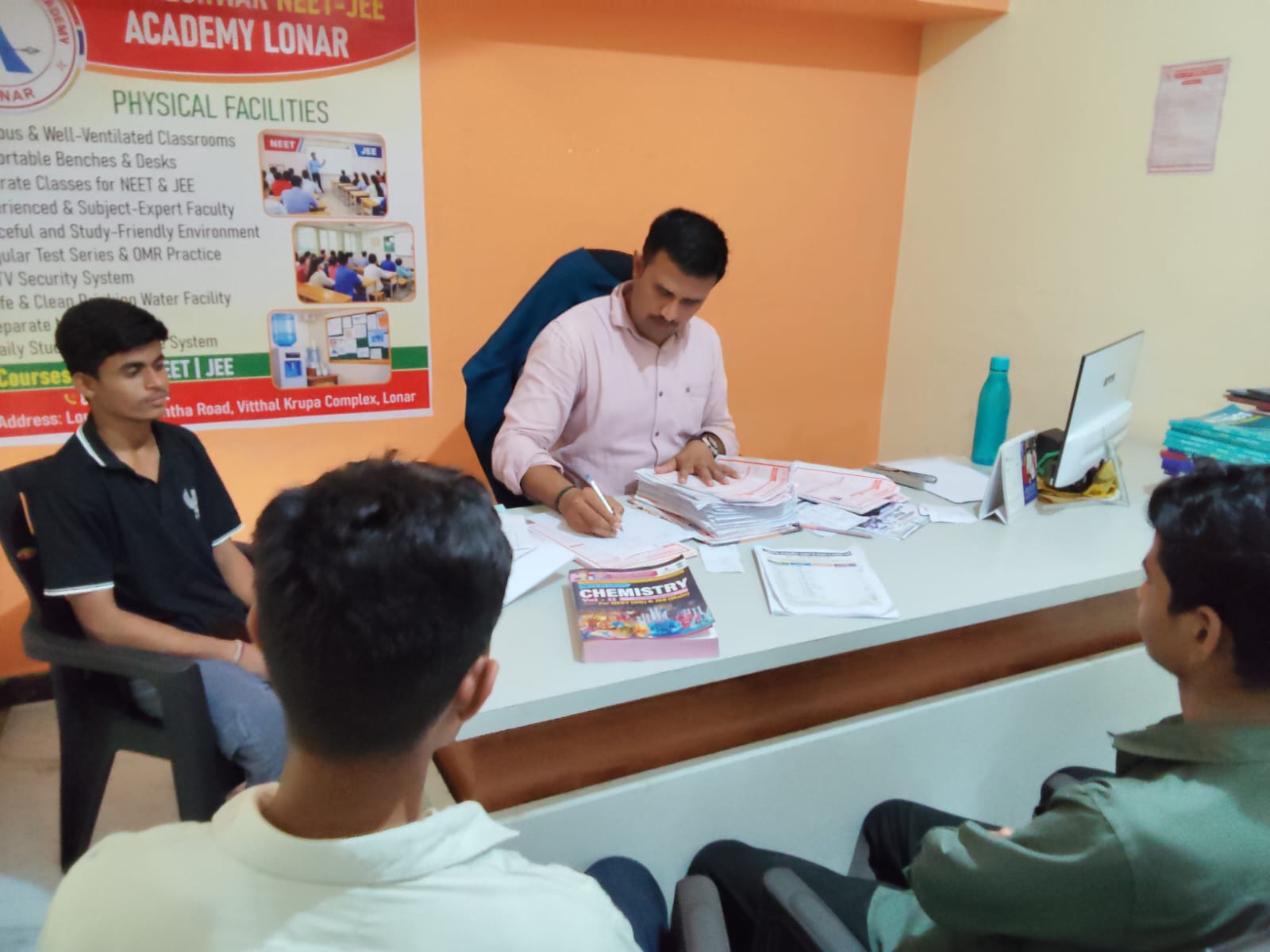 Students receiving admission documentation and academic support at Khadkeshwar NEET-JEE Academy, Lonar.