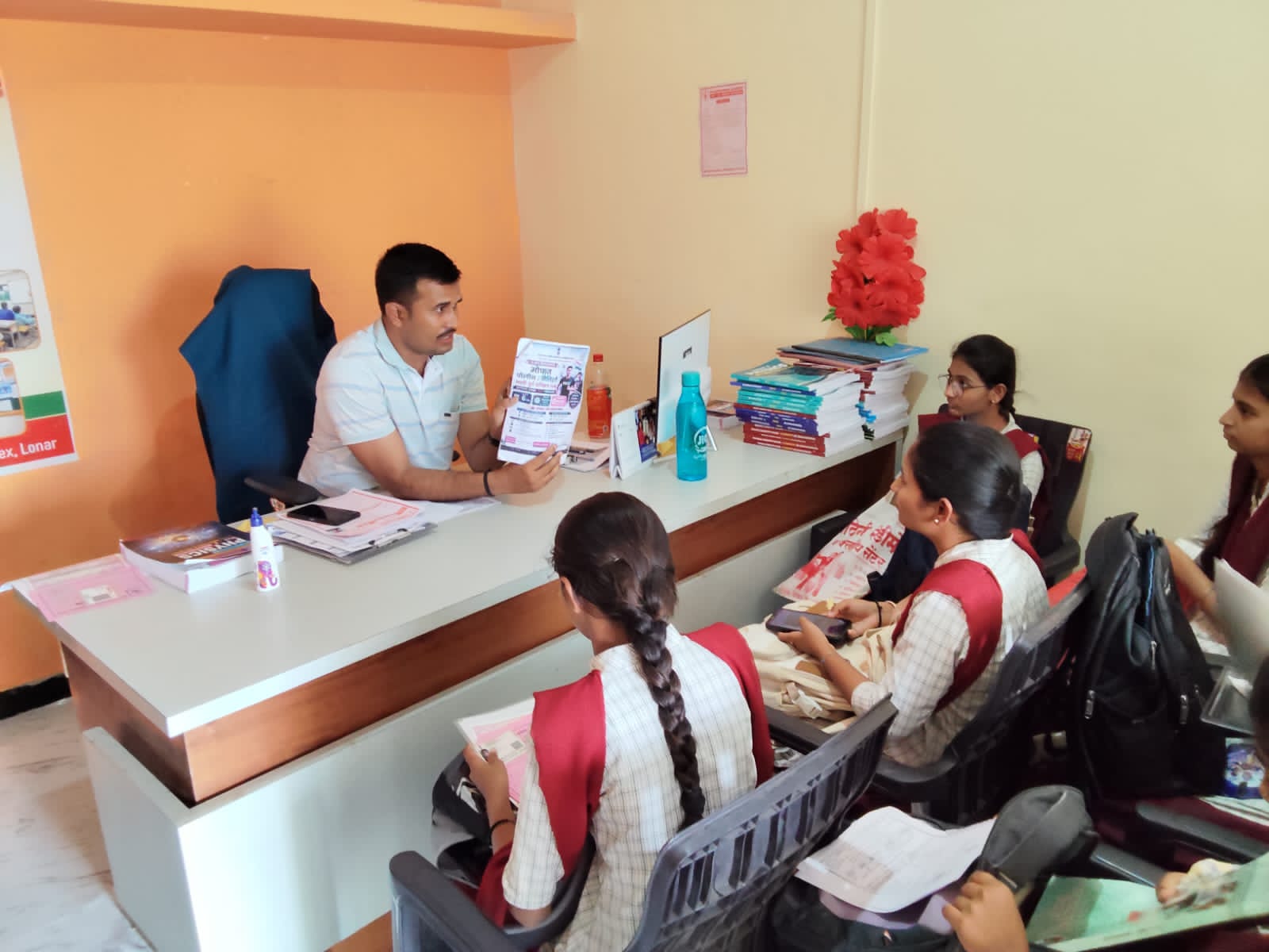 Faculty explaining NEET-JEE course information and study opportunities to students at Khadkeshwar NEET-JEE Academy, Lonar.