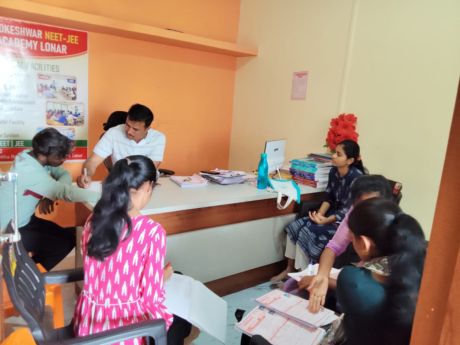 Faculty explaining NEET-JEE course and admission information during a student guidance session at Khadkeshwar NEET-JEE Academy, Lonar.