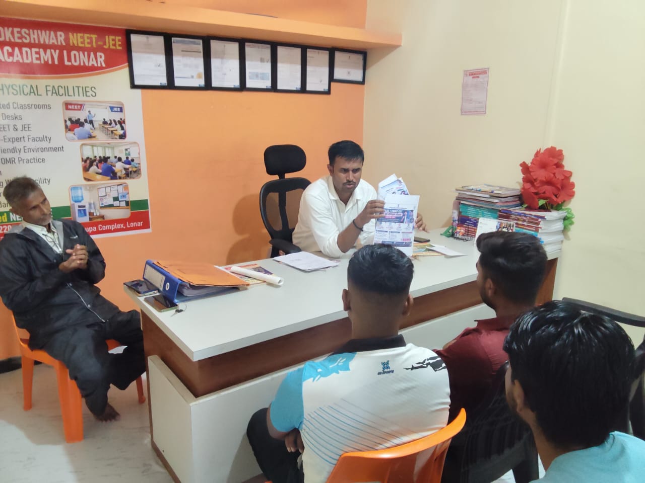 Faculty explaining NEET-JEE course and admission information during a student guidance session at Khadkeshwar NEET-JEE Academy, Lonar.
